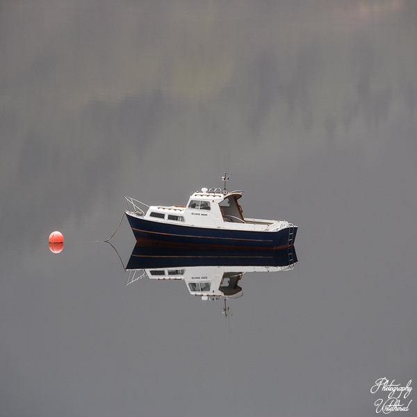 Reflection in Loch Long of a fishing boat called the Island Maid. Scottish Landscape Photography.