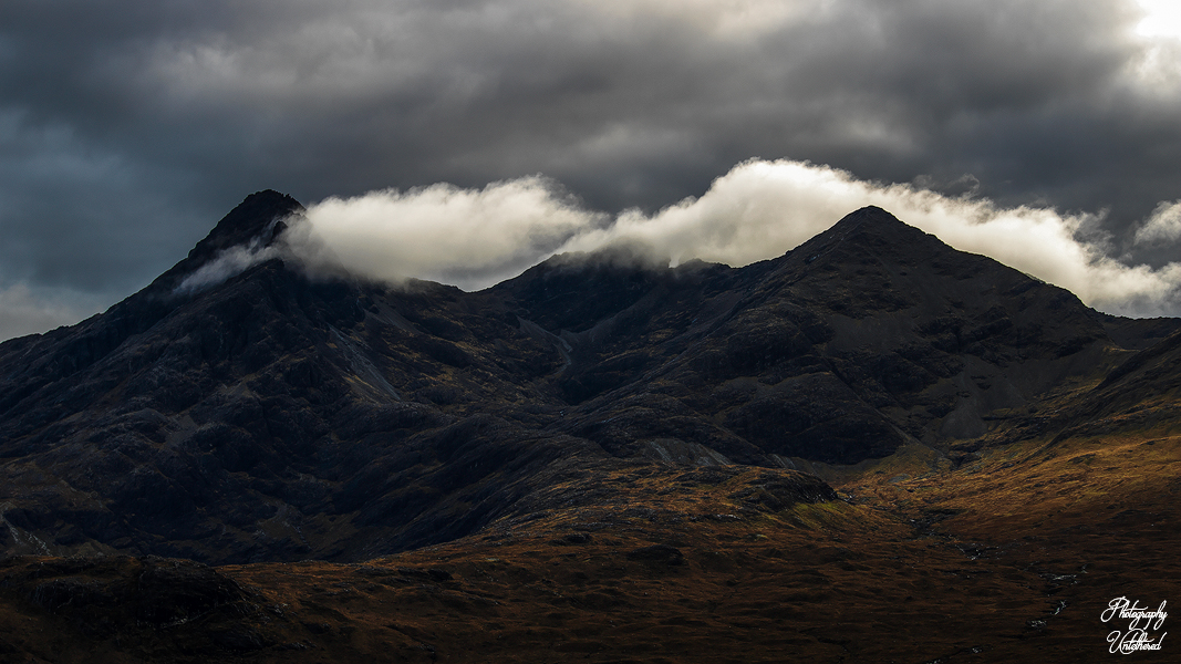 Peaks of Sgùrr nan Gillean with a dark sky and clouds. Scottish Landscape Photography.