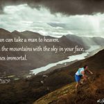 A man in athletic gear climbs a grassy mountain slope overlooking a vast valley with a river under a cloudy sky. Inspirational text overlays the scene. #LifeStyleUntethered
